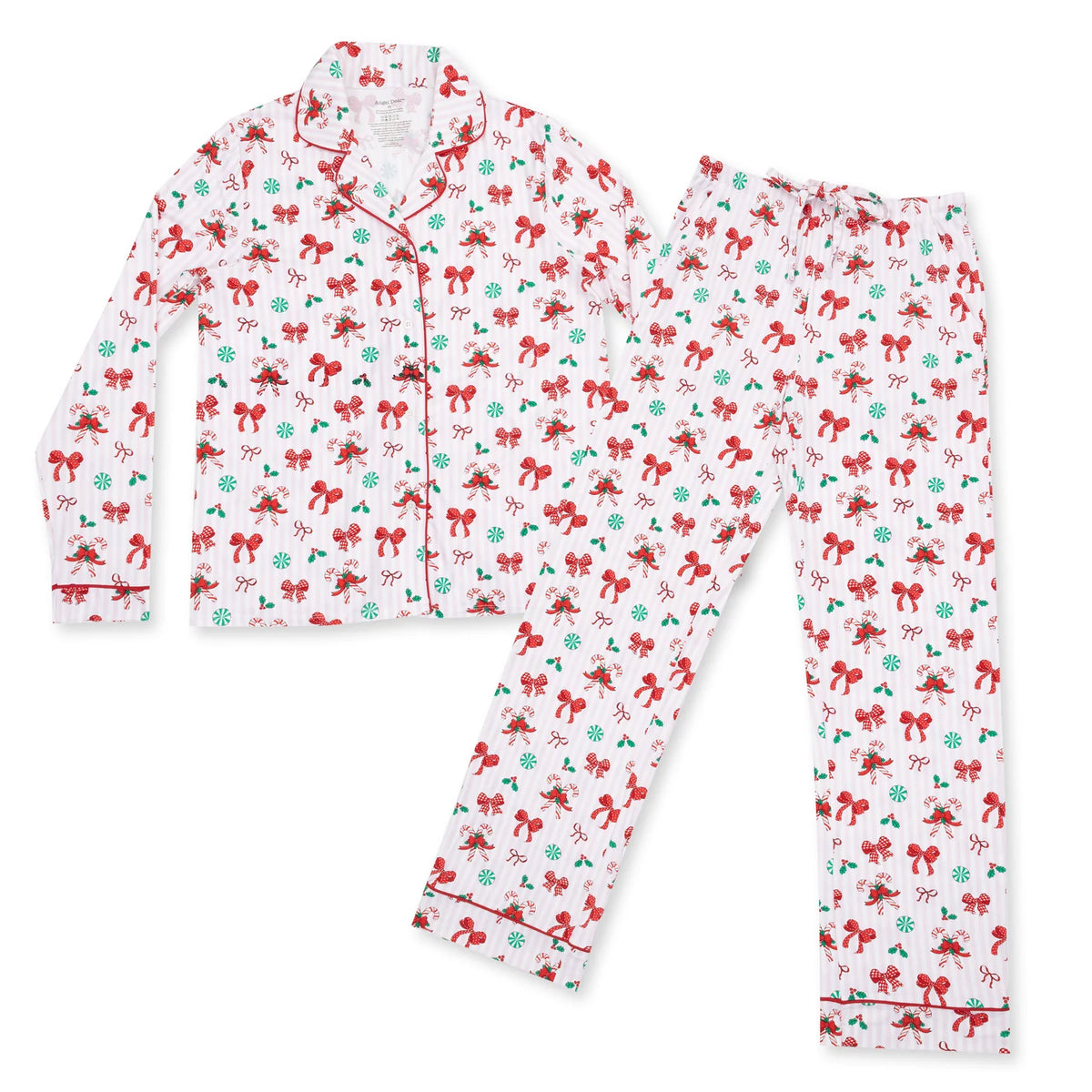 A two-piece pajama set consisting of a long-sleeve button-front top and matching pants, both printed with a festive holiday pattern of red bows, green snowflakes, and red-and-white striped candy canes on a white background.