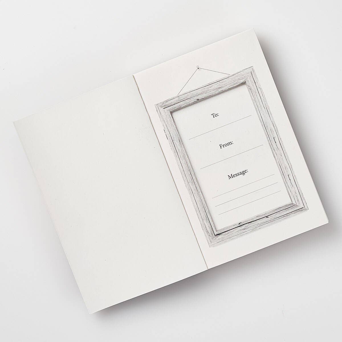 White greeting card with a gray wooden frame on a white background
