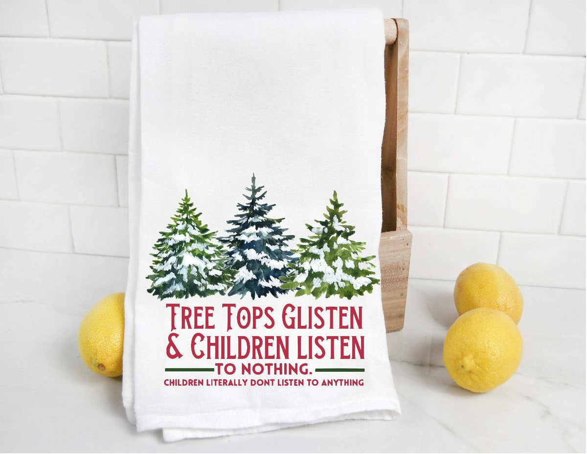 Tea towel with forest design and humorous text on a kitchen counter with lemons.