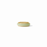 Green ceramic ring dish on a white background