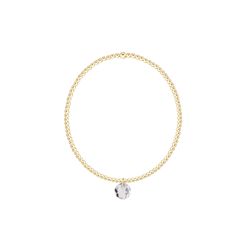 Gold necklace with a round pendant on a white background