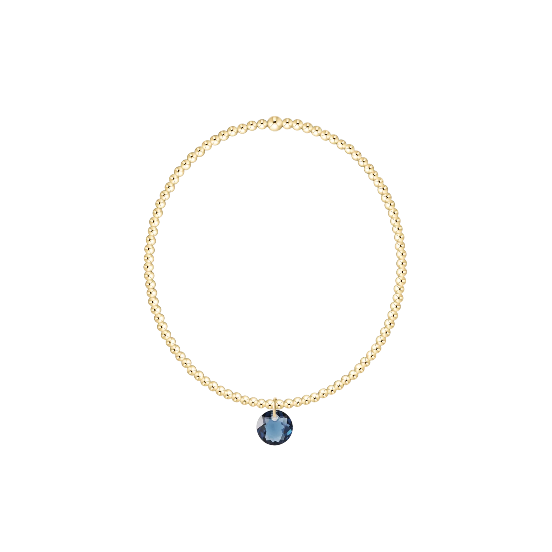 Gold necklace with a blue gemstone pendant on a white background