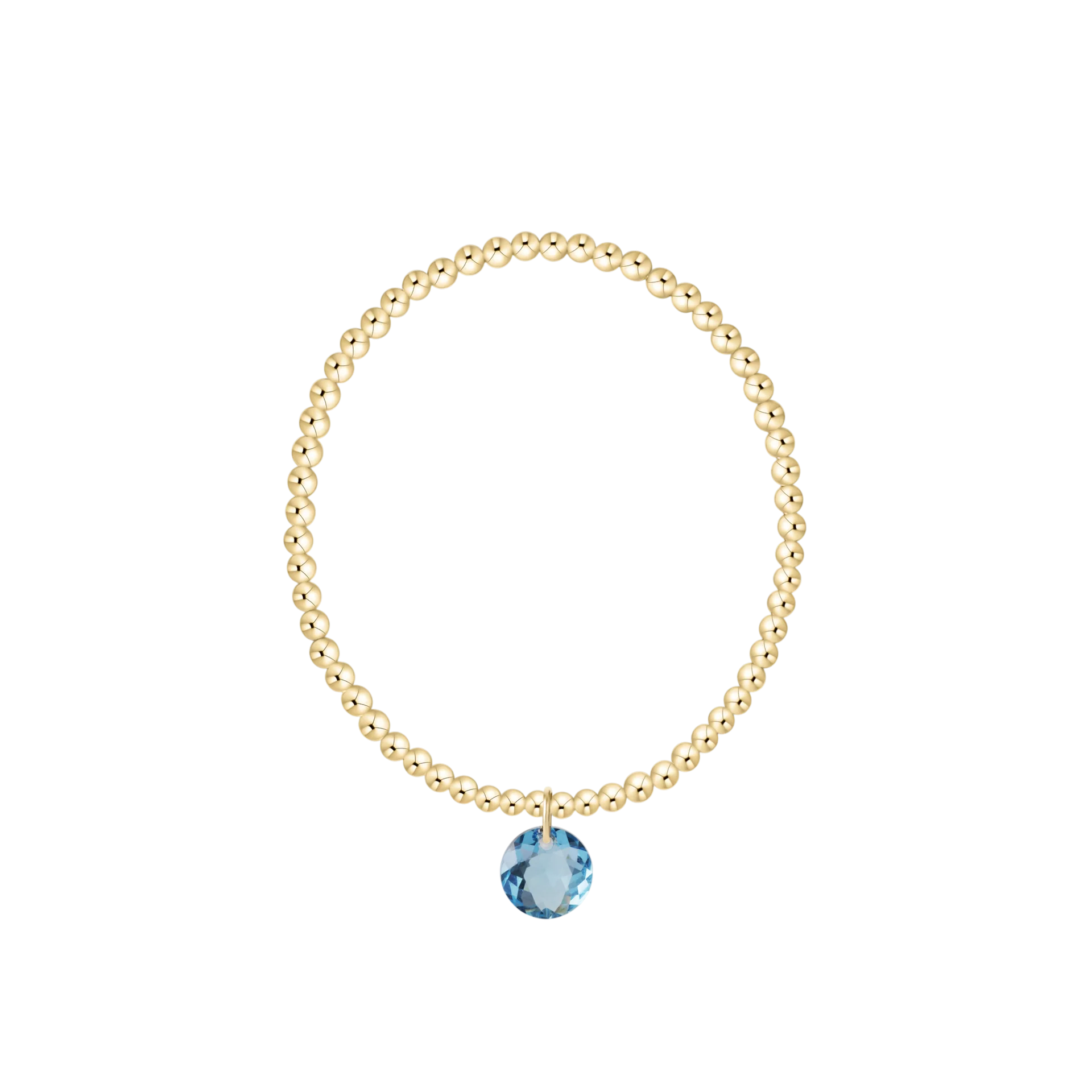 Gold bracelet with a blue gemstone on a white background