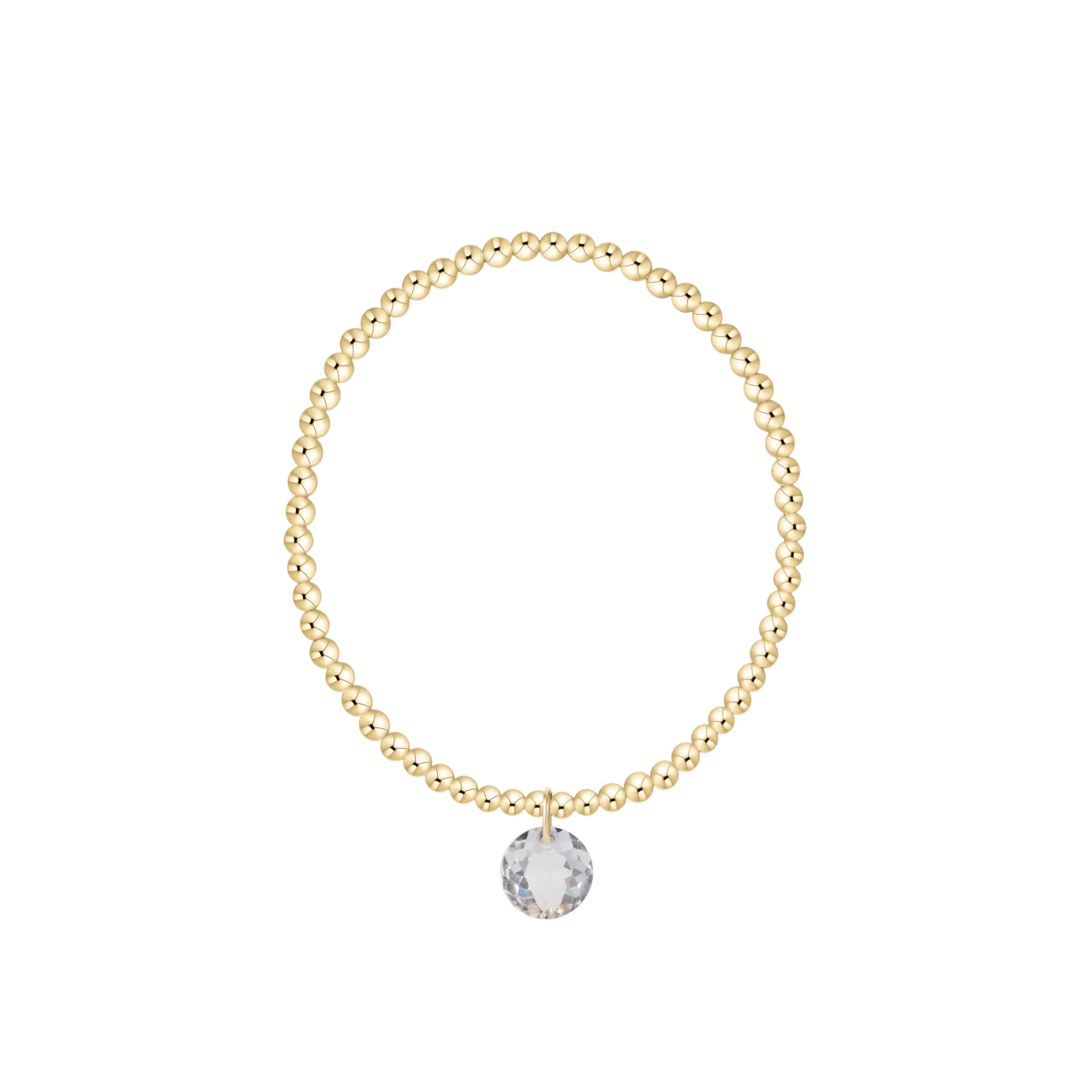 Gold beaded bracelet with a clear crystal charm on a white background
