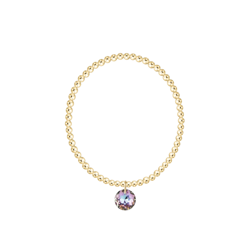 Gold beaded bracelet with pink gemstone charm