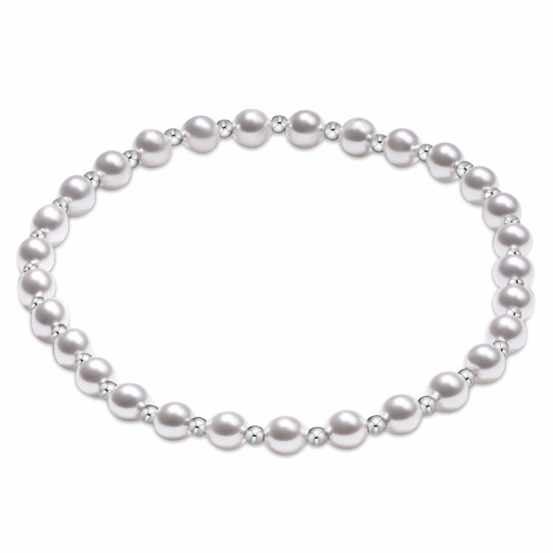 A silver beaded bracelet with alternating large and small round beads, arranged in a circle on a plain white background.