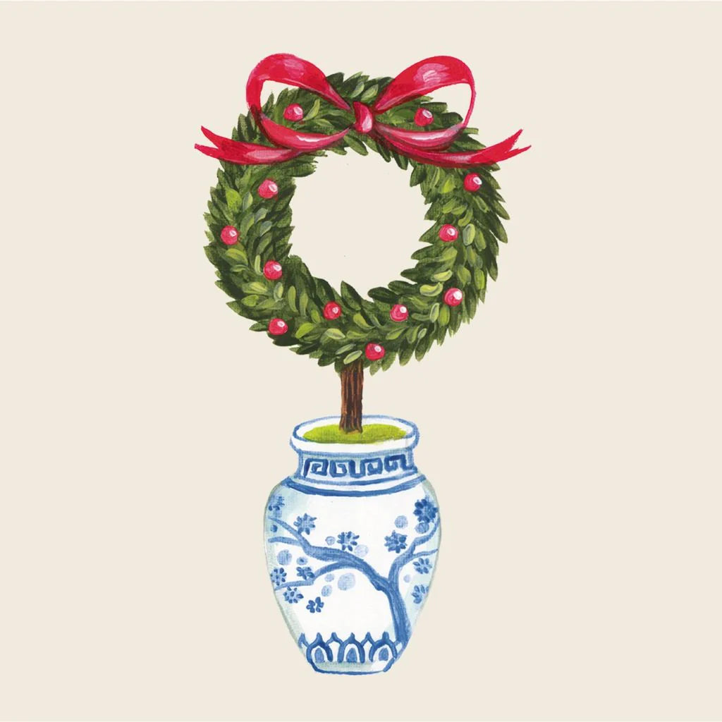Topiary in a decorative pot with a red ribbon on a beige background