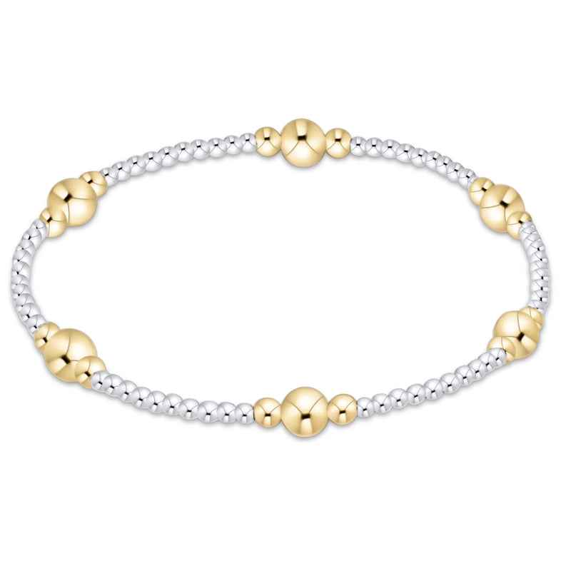 A two-tone beaded bracelet featuring textured silver beads and polished yellow gold bead accents, displayed on a clean white background.