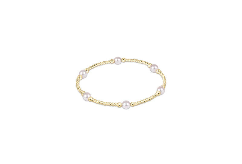 A delicate gold chain bracelet featuring five evenly spaced white freshwater pearls, displayed on a clean white background.