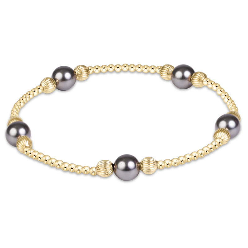A gold beaded bracelet featuring five dark gray freshwater pearls spaced evenly along the chain, set against a plain white background.