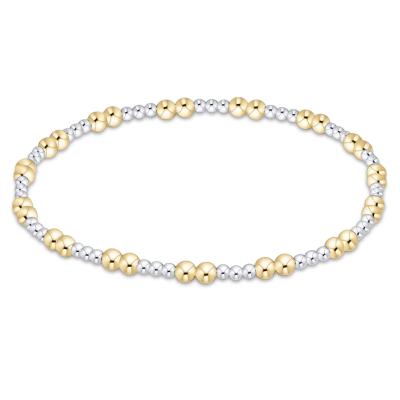A two-tone beaded stretch bracelet featuring polished yellow gold and silver-toned metallic beads, displayed against a solid white background.

