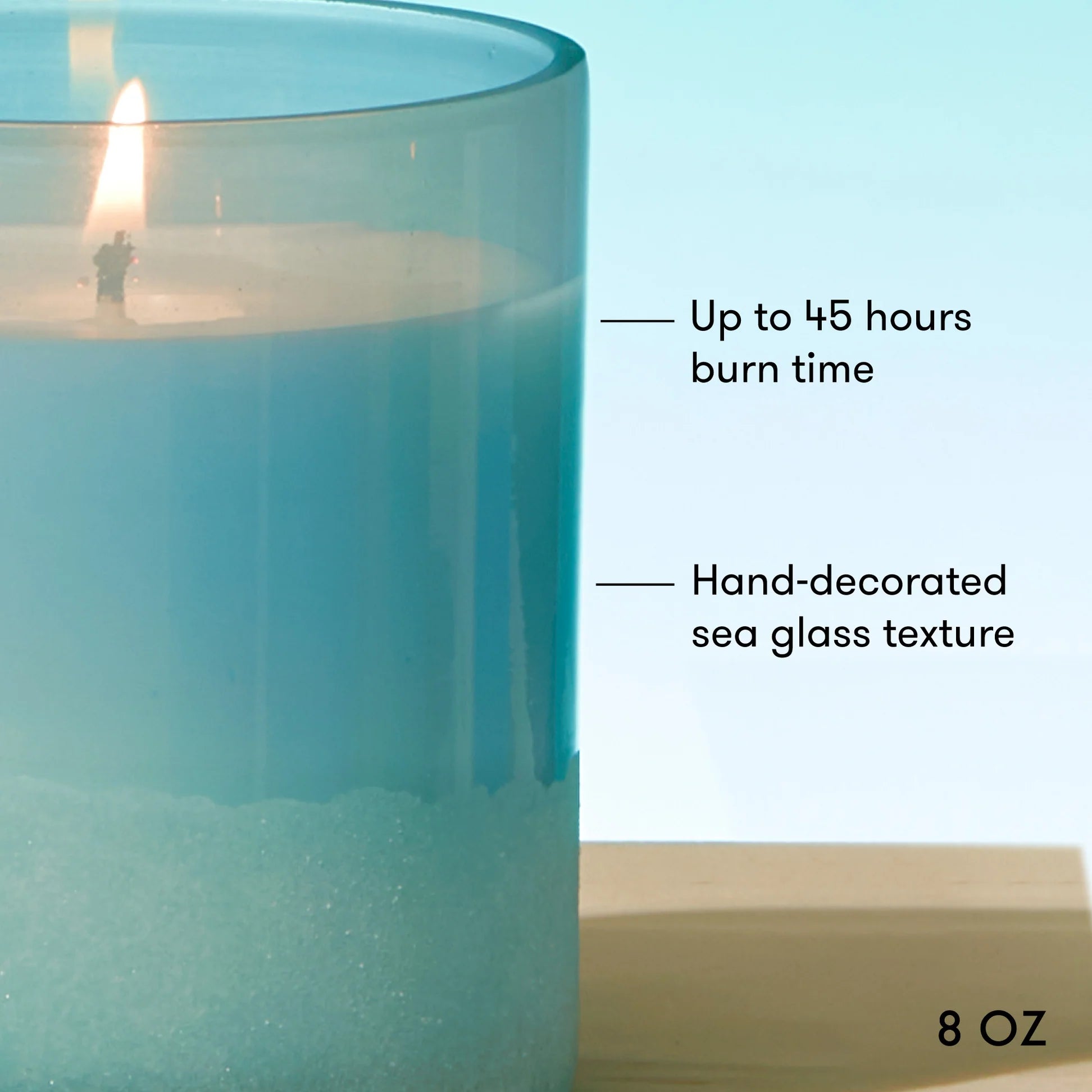Teal candle with decorative sea glass texture and text indicating burn time and size.