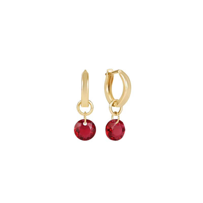 Gold hoop earrings with red gemstones on a white background