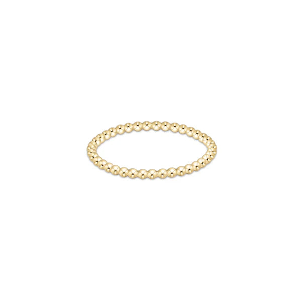 Gold beaded bracelet on a white background