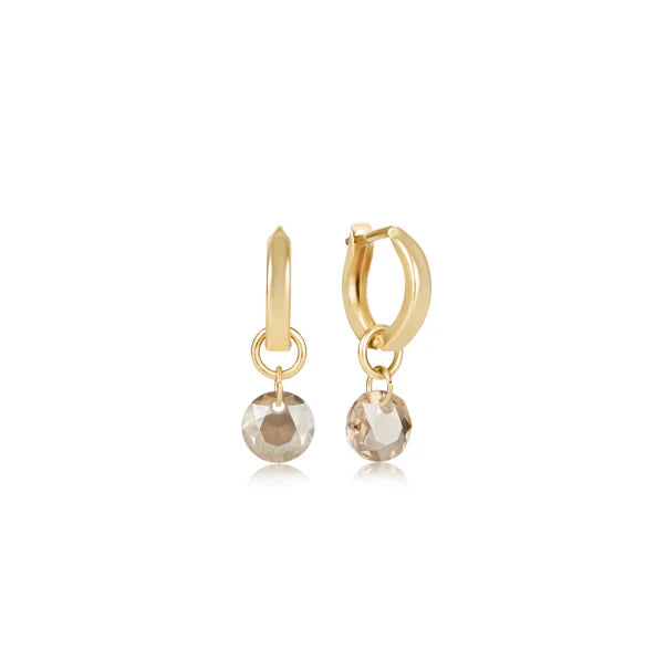 Gold hoop earrings with round gemstones on a white background