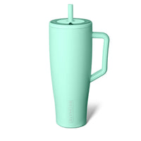 Mint green tumbler with a straw on a white background