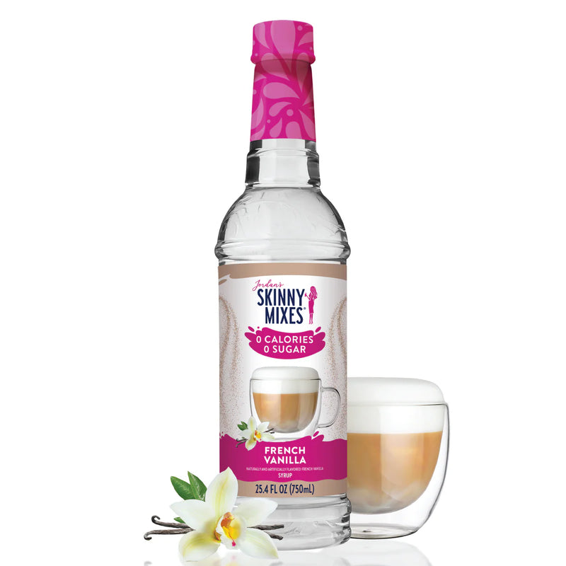 Skinny Mixes French Vanilla syrup bottle with a glass of coffee and vanilla flower on a white background