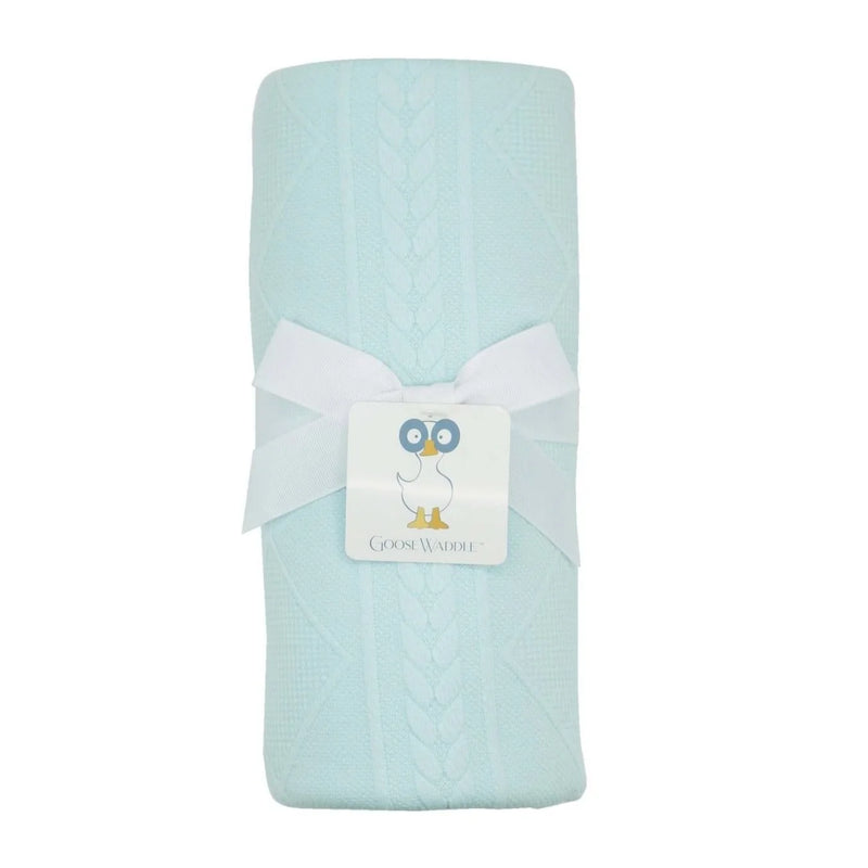 A light aqua blue cable-knit baby blanket wrapped with a white ribbon and a Goose Waddle brand tag, set against a plain white background.