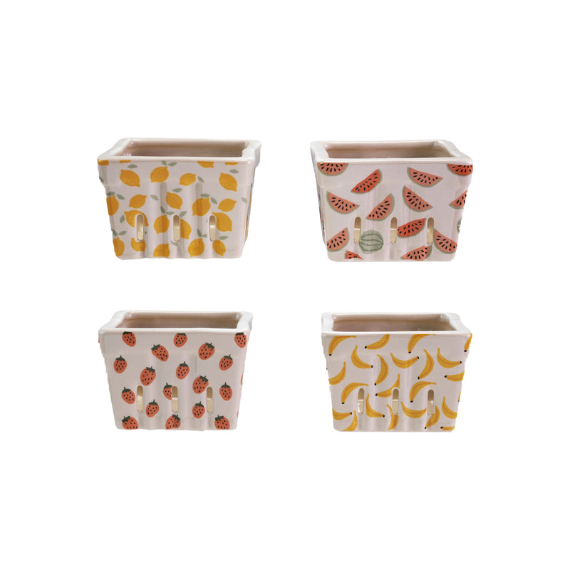 Four square ceramic baskets with fruit pattern on a white background