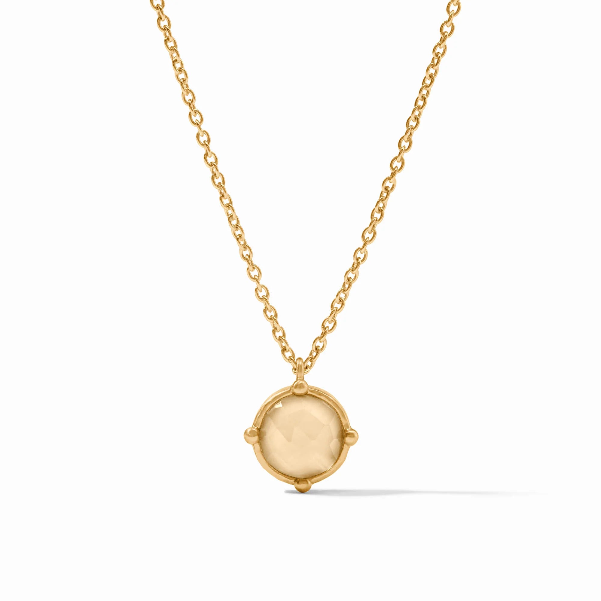 Gold necklace with a round pendant on a white background