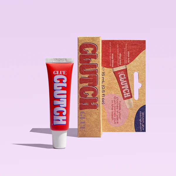 Red 'Clutch' glue tube and packaging on a light purple background