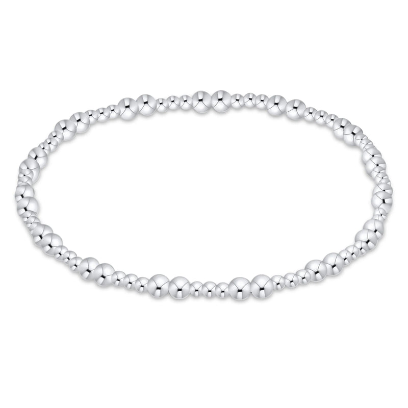 A silver beaded stretch bracelet with polished metallic spherical beads, displayed in a horizontal oval shape against a plain white background.