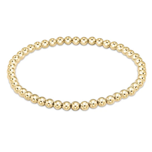 Gold beaded bracelet on a white background