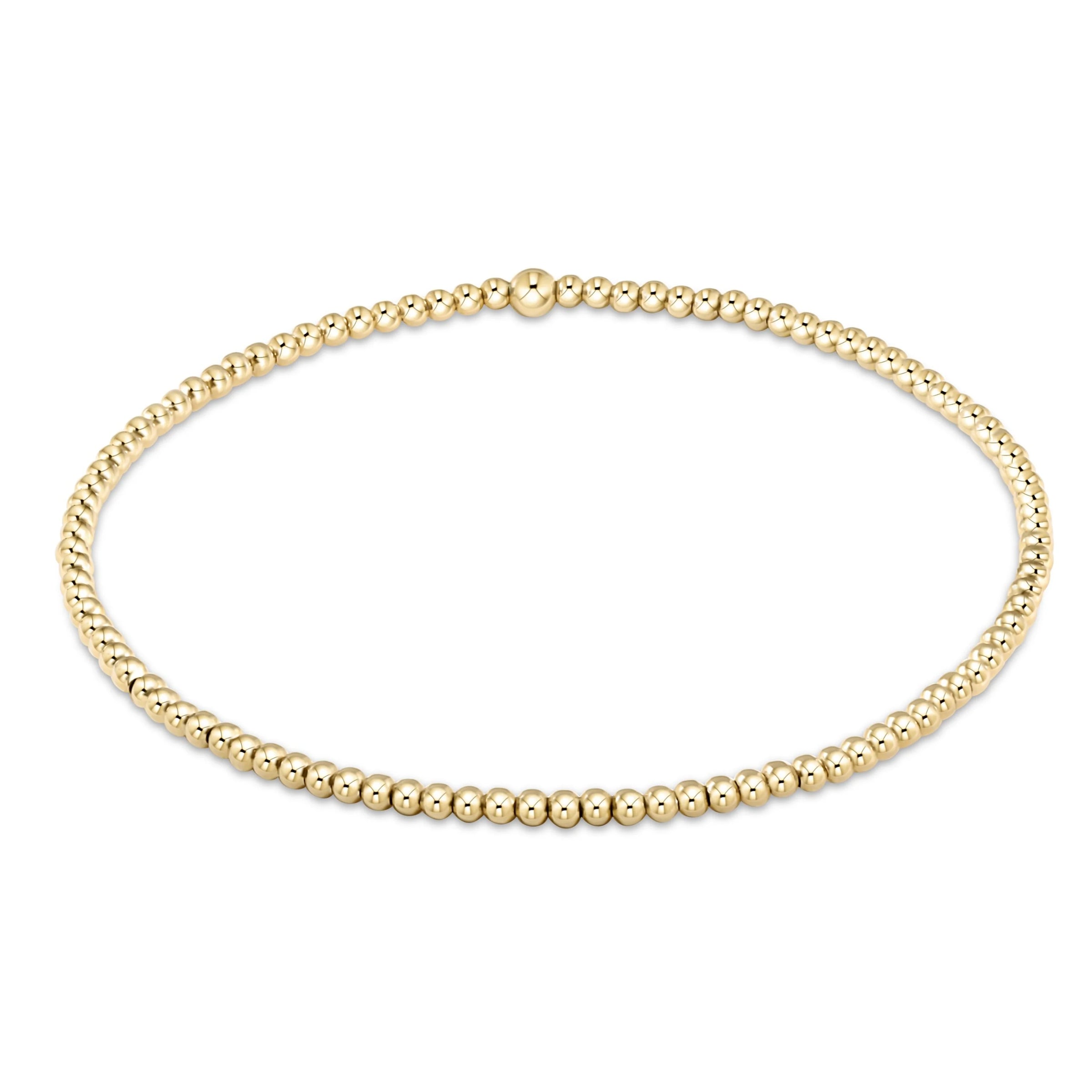 Gold beaded bracelet on a white background