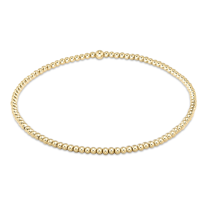 Gold beaded bracelet on a white background
