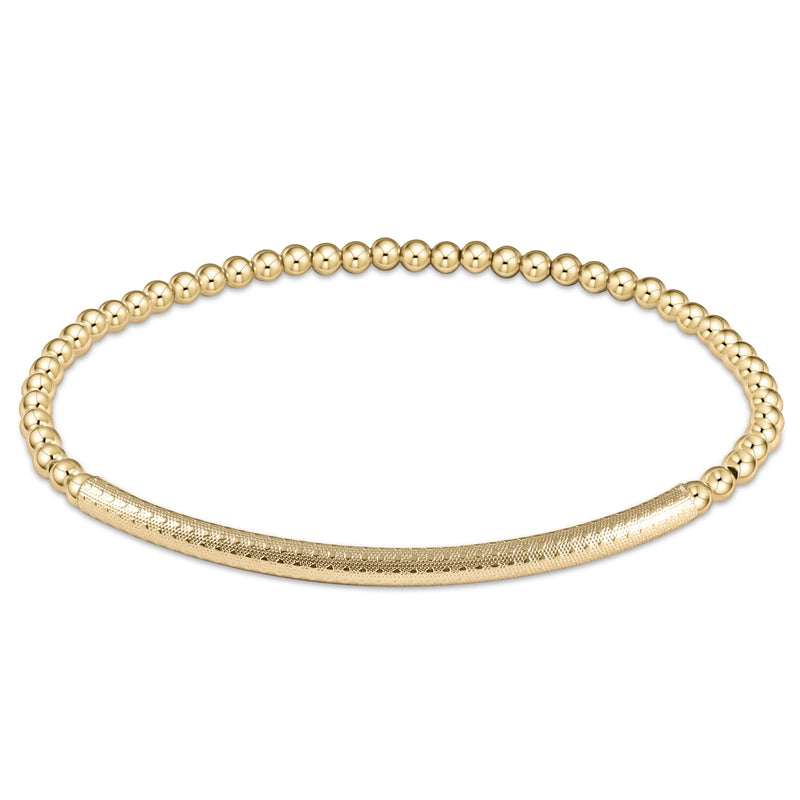 Gold beaded bracelet on white background