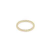Gold beaded ring on white background