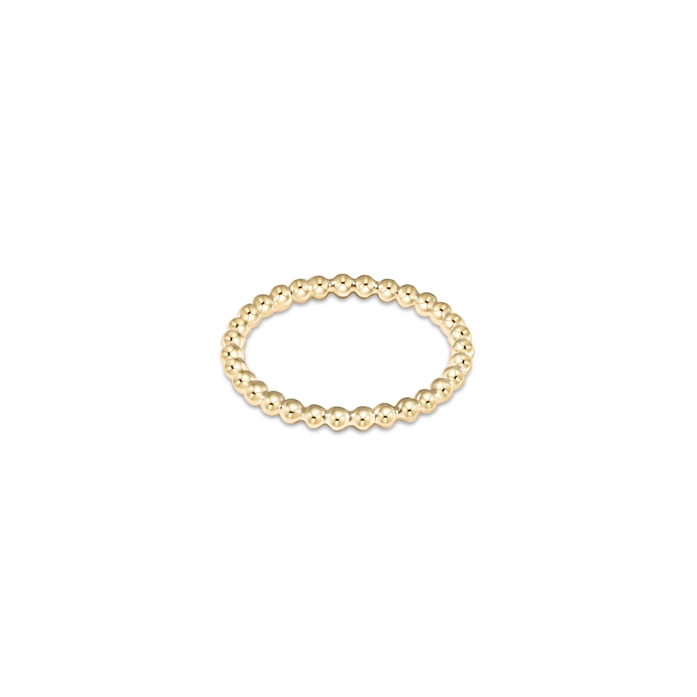 Gold beaded ring on white background