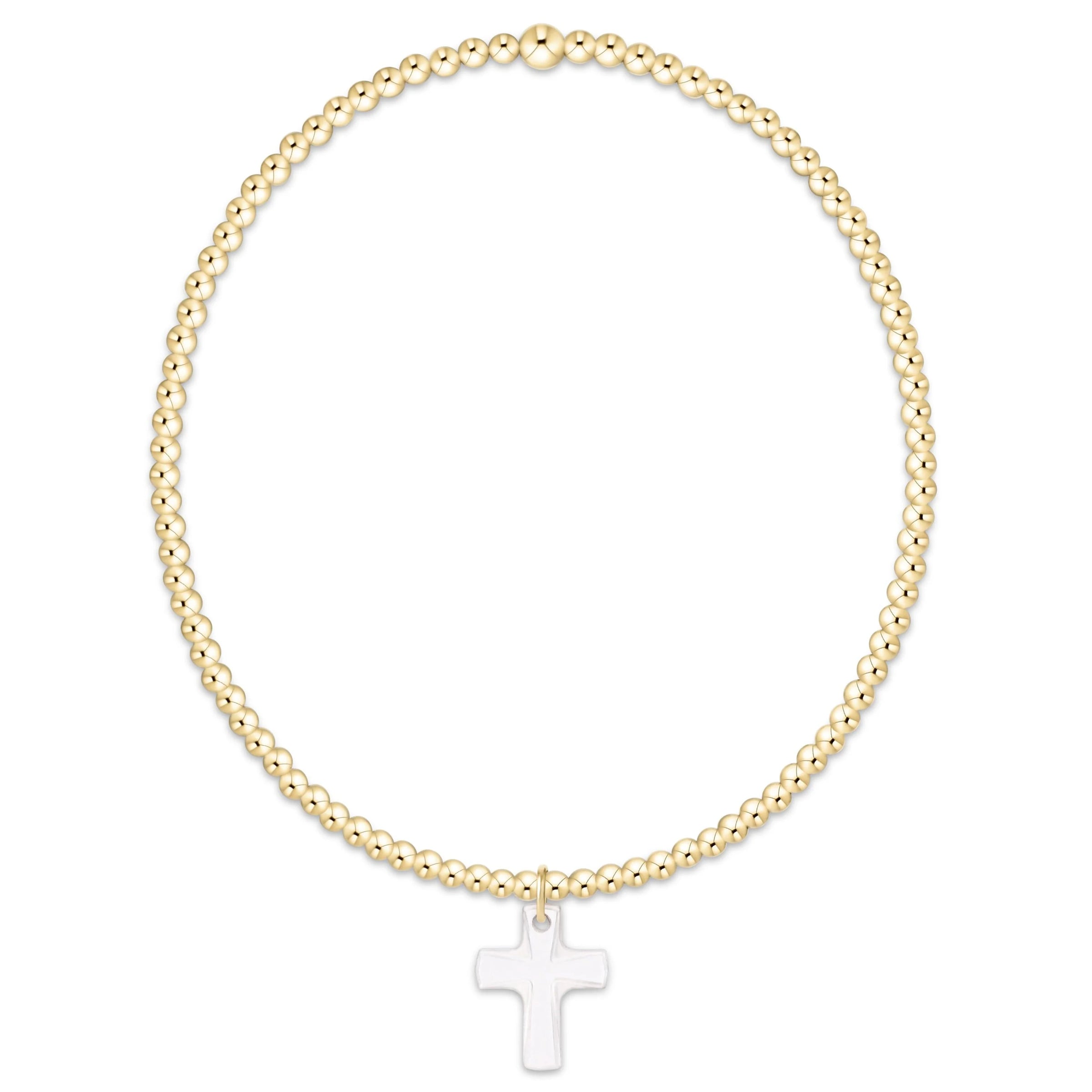Gold beaded bracelet with a white cross pendant on a white background