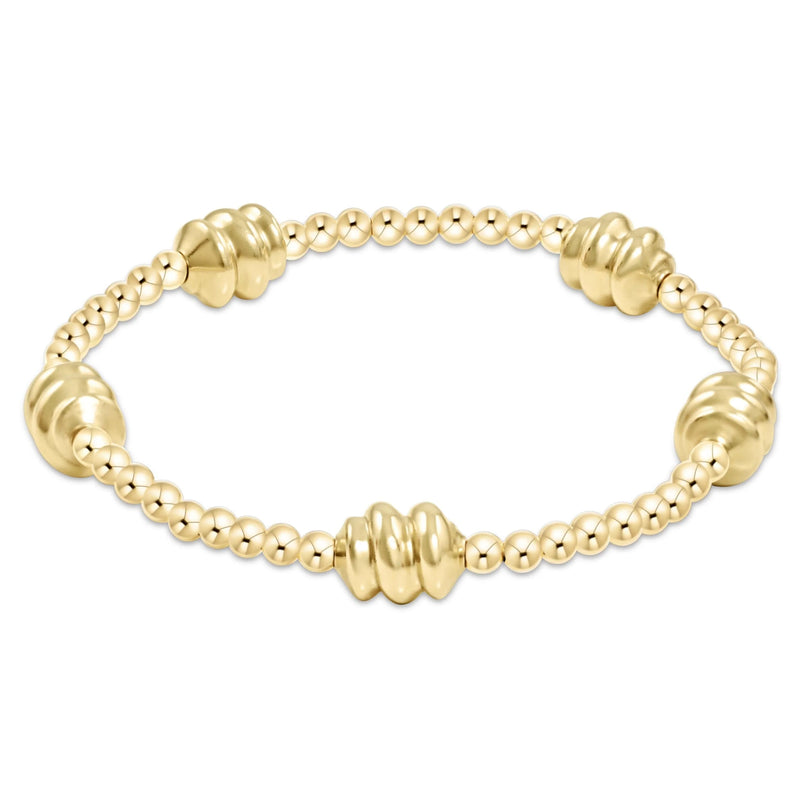 Gold beaded bracelet with larger swirled beads