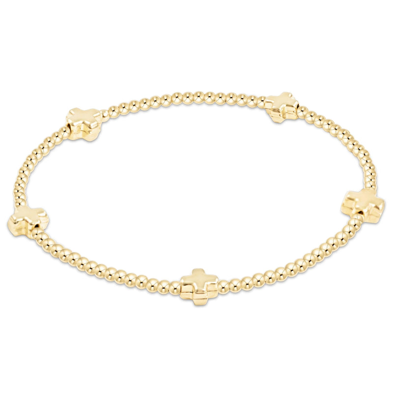 Gold beaded bracelet with small crosses