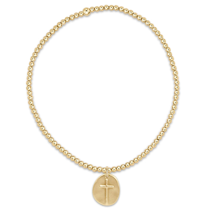 Gold beaded necklace with a cross pendant on a white background