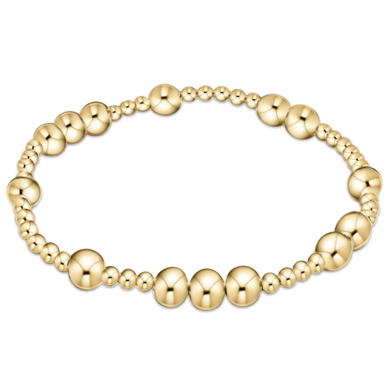 Gold beaded bracelet on white background

