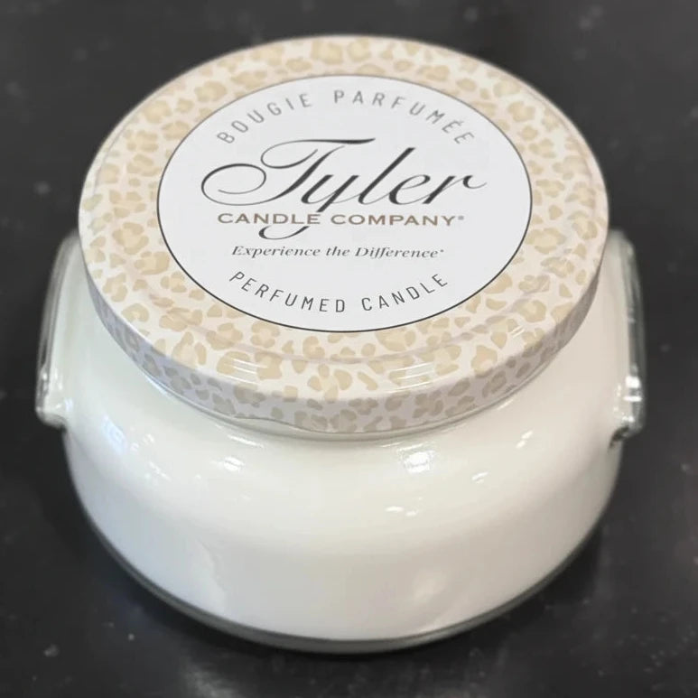 Tyler Candle Company candle with leopard print lid on a dark background