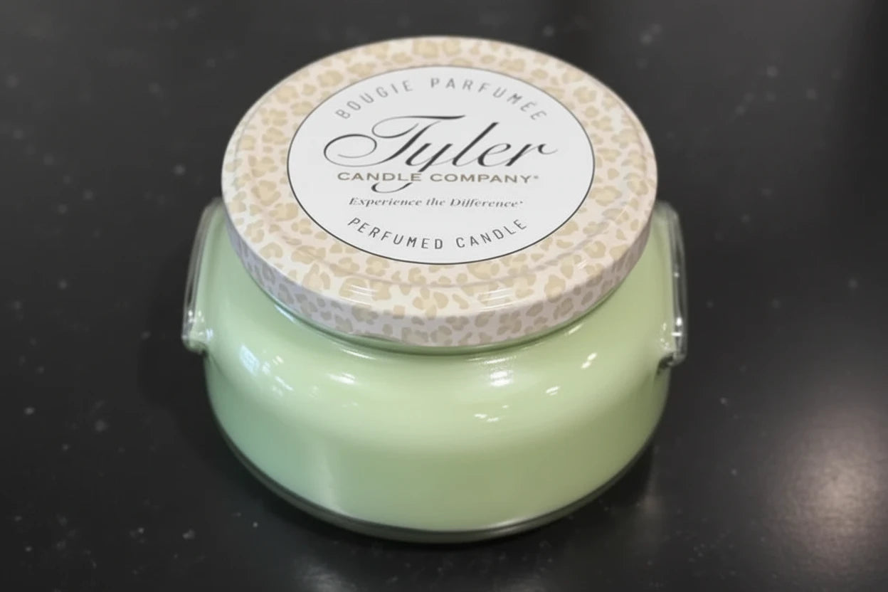 Tyler Candle Company candle with leopard print lid on a dark background