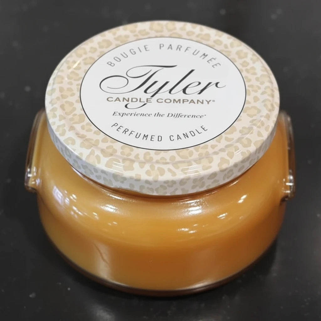 Tyler Candle Company candle with a textured lid on a black background