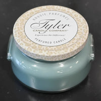 Tyler Candle Company candle with leopard print lid on a dark background