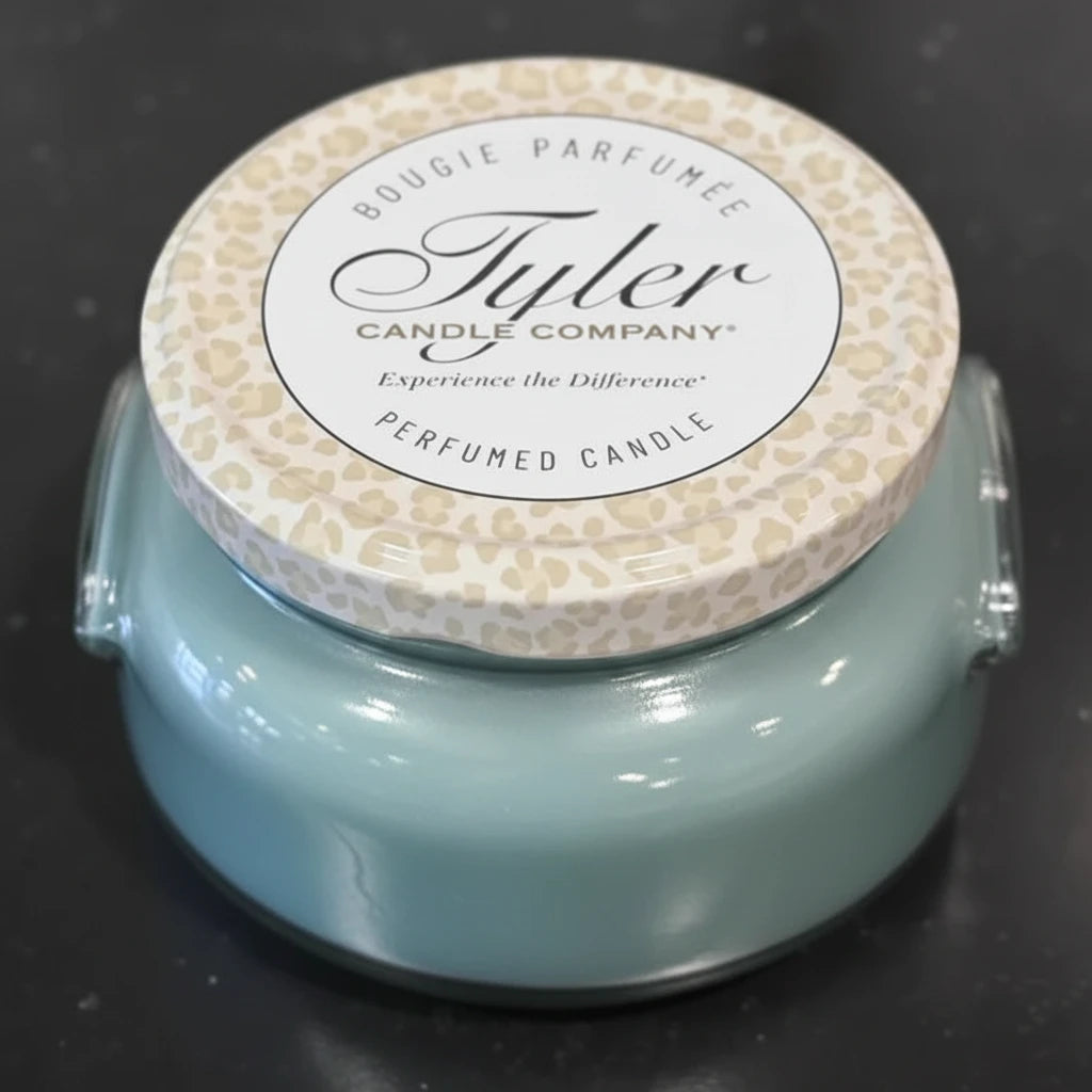 Tyler Candle Company candle with leopard print lid on a dark background