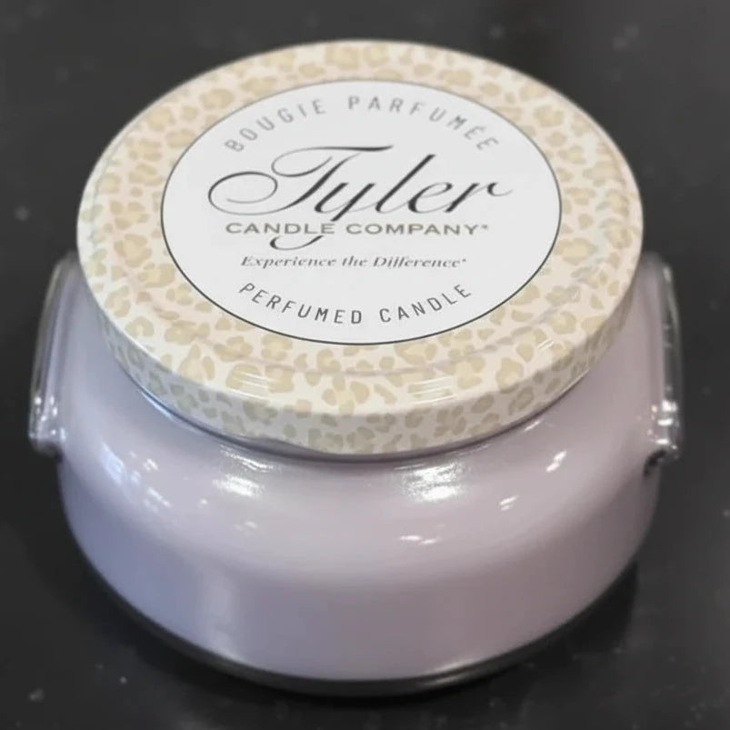 Tyler Candle Company candle with leopard print lid on a dark background