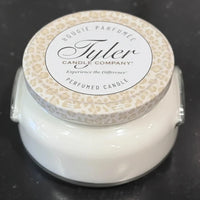 Tyler Candle Company candle with a textured lid on a black surface