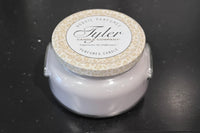 Tyler Candle Company candle with a textured lid on a black surface