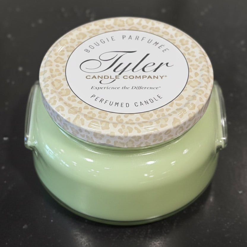 Tyler candle with a patterned lid on a dark surface