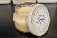 Tyler candle with lid on a dark surface