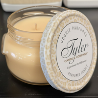 Tyler Candle Company candle with leopard print lid on a dark surface