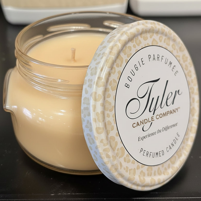 Tyler Candle Company candle with leopard print lid on a dark surface