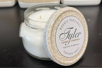 Tyler Candle Company candle with a decorative lid on a dark surface